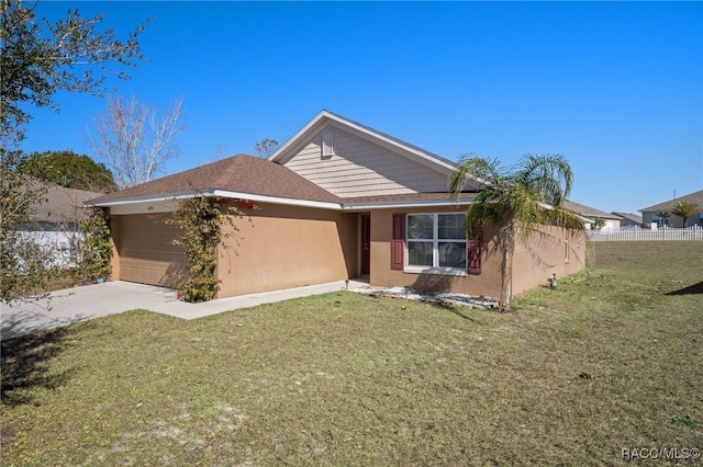 view of front of house with a garage and a front lawn