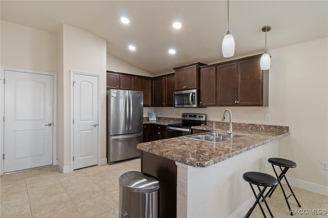 kitchen with pendant lighting, sink, appliances with stainless steel finishes, dark brown cabinets, and kitchen peninsula