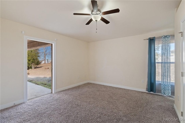 carpeted spare room with ceiling fan