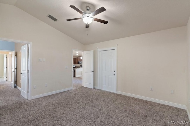 unfurnished bedroom with ceiling fan, light colored carpet, and vaulted ceiling