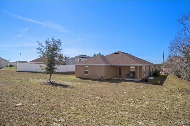 back of house featuring a yard and a patio