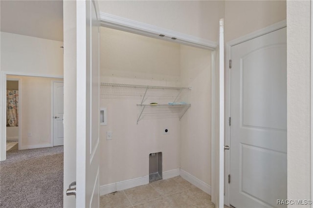 laundry room featuring light carpet and electric dryer hookup