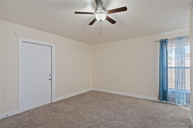 carpeted spare room featuring ceiling fan