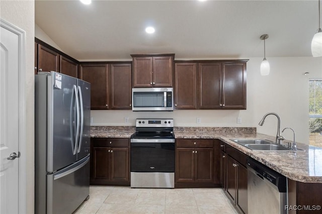 kitchen featuring sink, light tile patterned floors, appliances with stainless steel finishes, kitchen peninsula, and pendant lighting