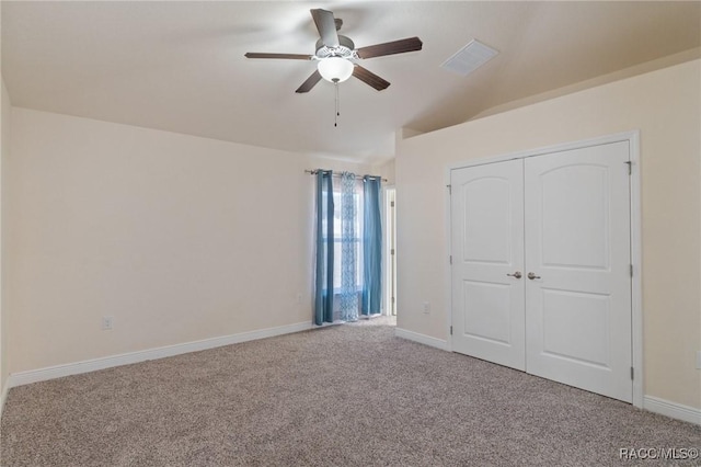 unfurnished bedroom featuring light carpet, ceiling fan, and a closet