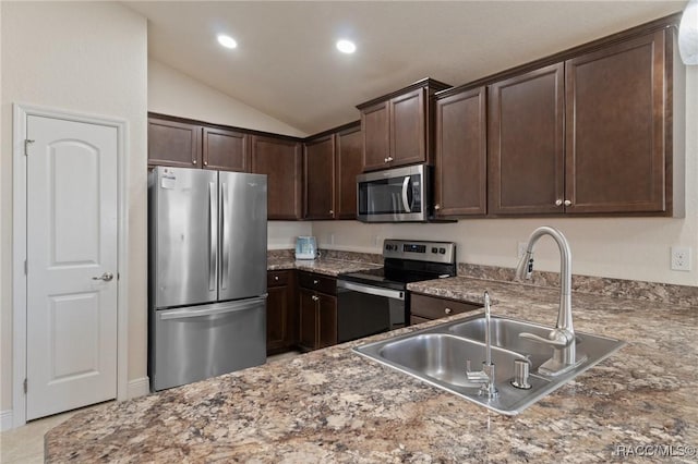 kitchen featuring lofted ceiling, appliances with stainless steel finishes, sink, and dark brown cabinets