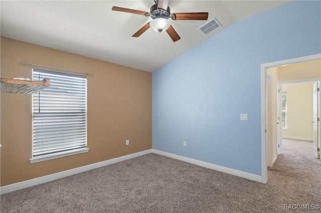 carpeted spare room with ceiling fan and lofted ceiling