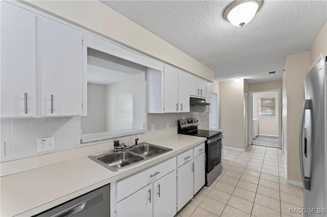 kitchen featuring decorative backsplash, sink, white cabinets, and appliances with stainless steel finishes