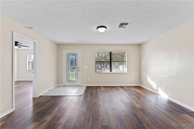 spare room with wood-type flooring, a textured ceiling, and ceiling fan