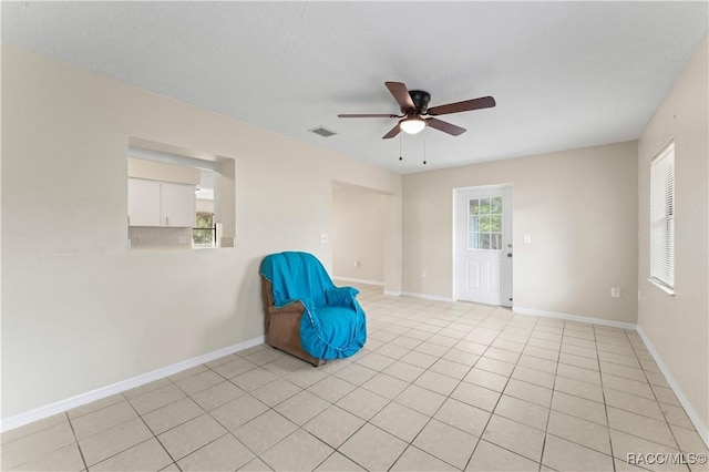 unfurnished room featuring ceiling fan and light tile patterned floors