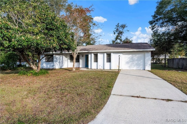 ranch-style house featuring a garage and a front lawn