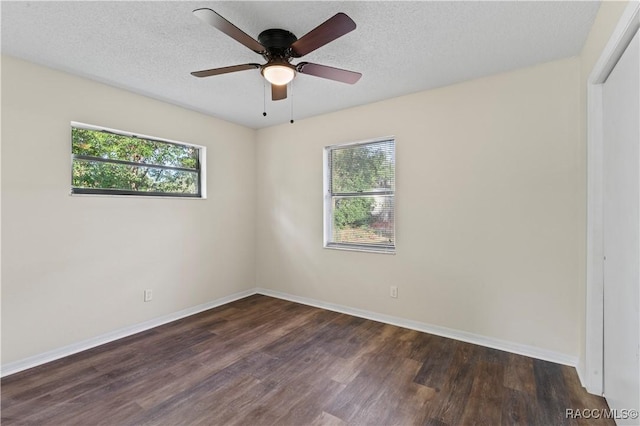 unfurnished room with ceiling fan, dark hardwood / wood-style flooring, and a textured ceiling