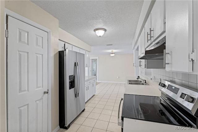 kitchen featuring tasteful backsplash, stainless steel appliances, sink, white cabinets, and light tile patterned flooring