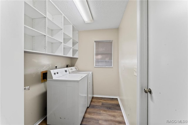 laundry area with separate washer and dryer, dark wood-type flooring, and a textured ceiling