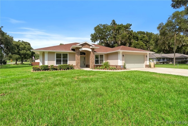 single story home with a garage and a front lawn