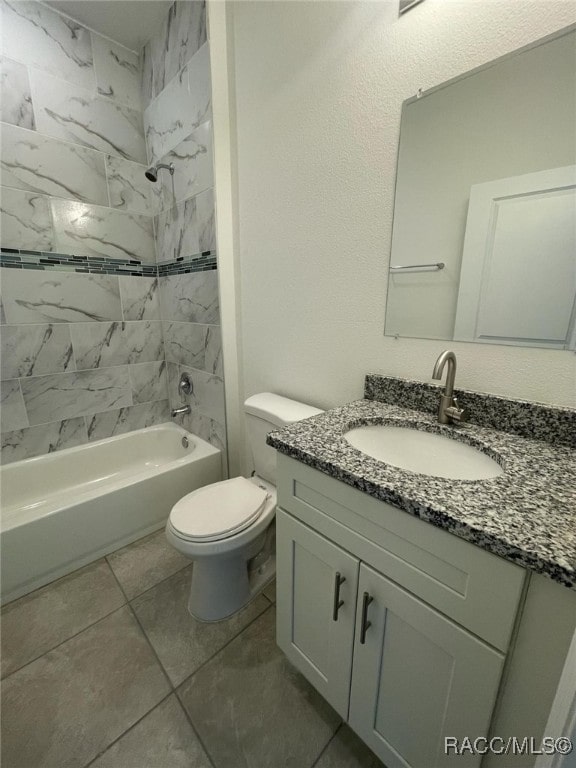 full bathroom featuring vanity, toilet, tile patterned flooring, and tiled shower / bath