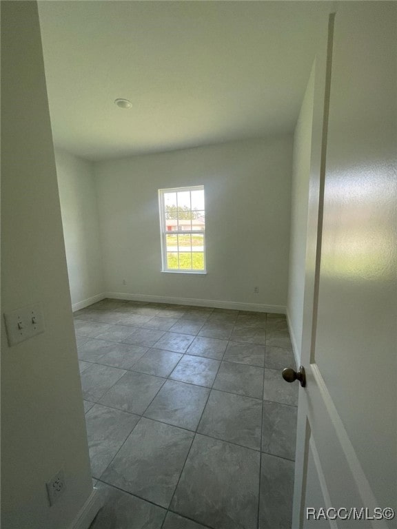 unfurnished room with light tile patterned floors