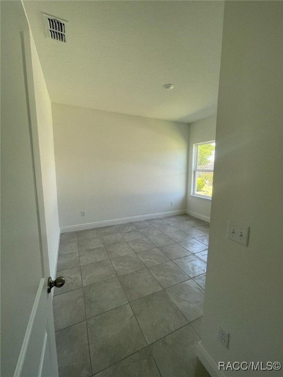 empty room with light tile patterned flooring