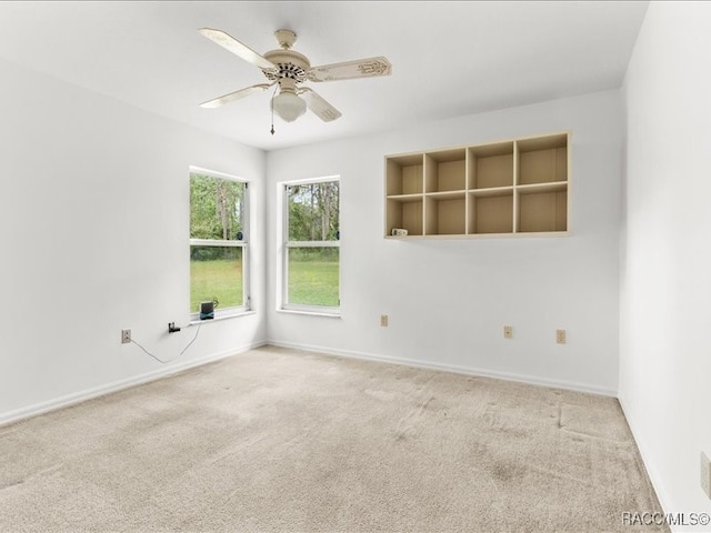 spare room with ceiling fan and carpet floors