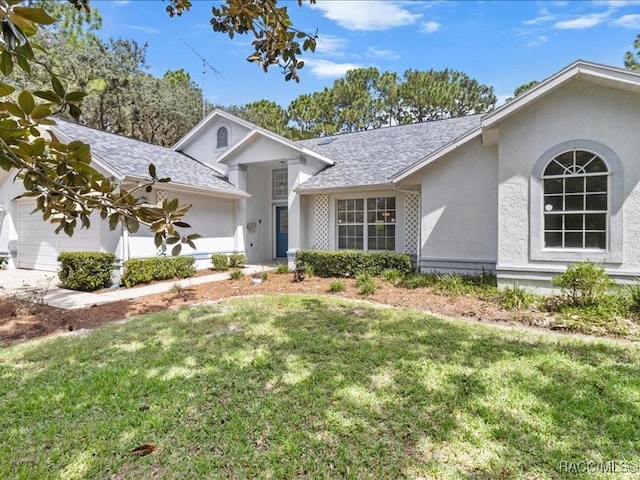 ranch-style home featuring a front yard and a garage