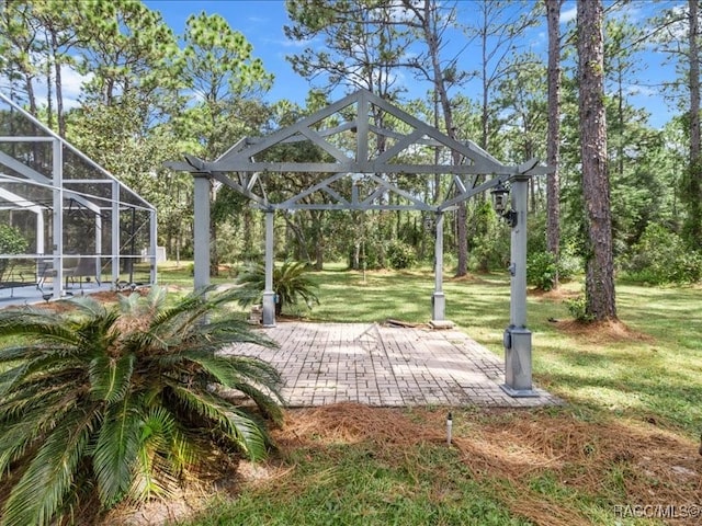 view of community featuring a yard and a patio