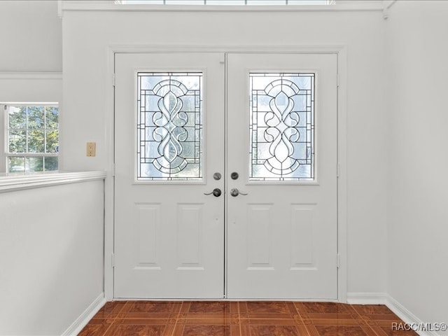 tiled entrance foyer featuring french doors