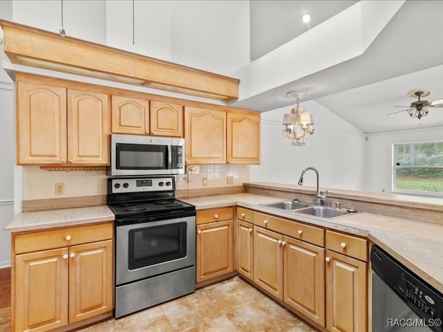 kitchen featuring appliances with stainless steel finishes, tasteful backsplash, ceiling fan with notable chandelier, sink, and lofted ceiling