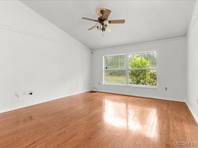 spare room featuring ceiling fan, lofted ceiling, and light wood-type flooring