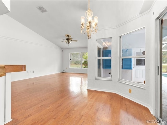 interior space featuring ceiling fan with notable chandelier, light wood-type flooring, and vaulted ceiling