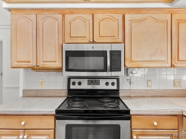 kitchen with light brown cabinetry, backsplash, and stainless steel appliances