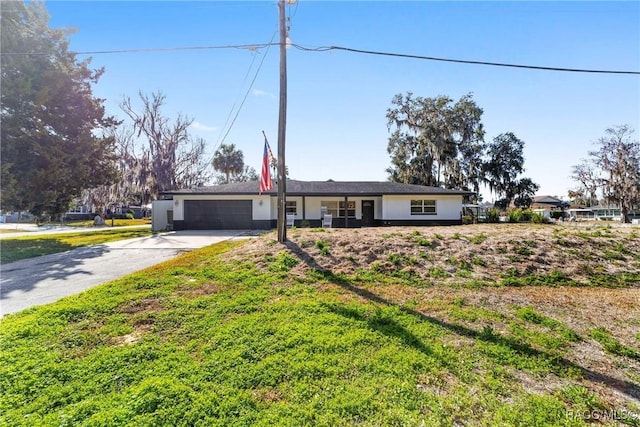 ranch-style home with a garage and a front yard