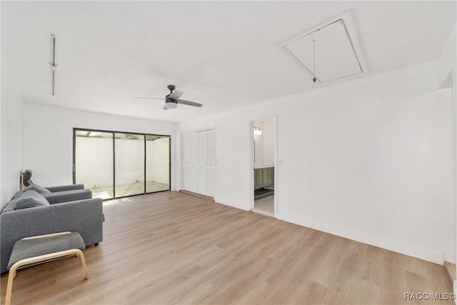 living room featuring ceiling fan and light wood-type flooring