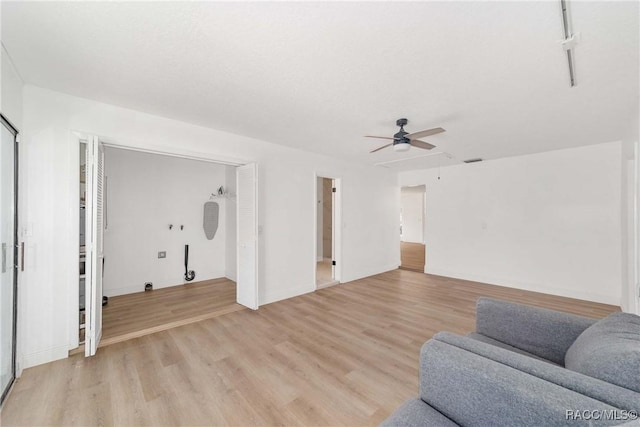 sitting room with ceiling fan and light hardwood / wood-style flooring