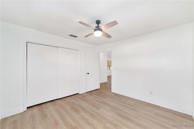 unfurnished bedroom featuring a closet, ceiling fan, and light hardwood / wood-style flooring