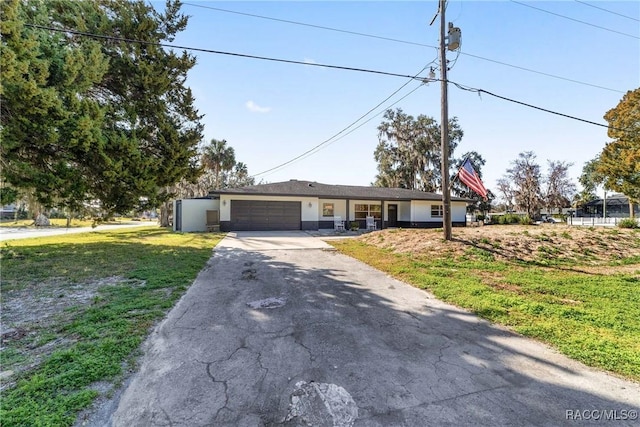 ranch-style house featuring a garage and a front yard