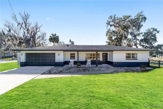 ranch-style home featuring a porch, a garage, and a front lawn