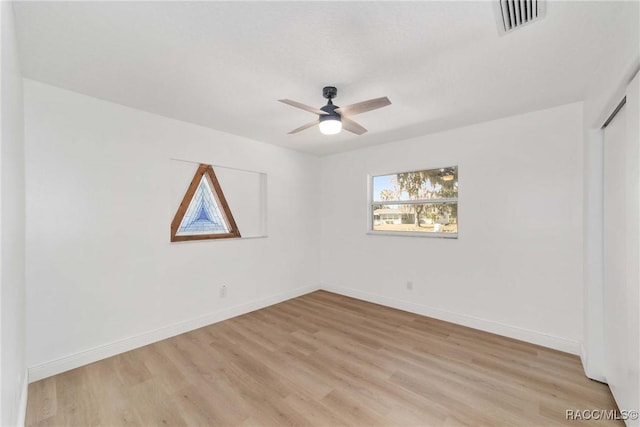 empty room featuring light hardwood / wood-style flooring and ceiling fan