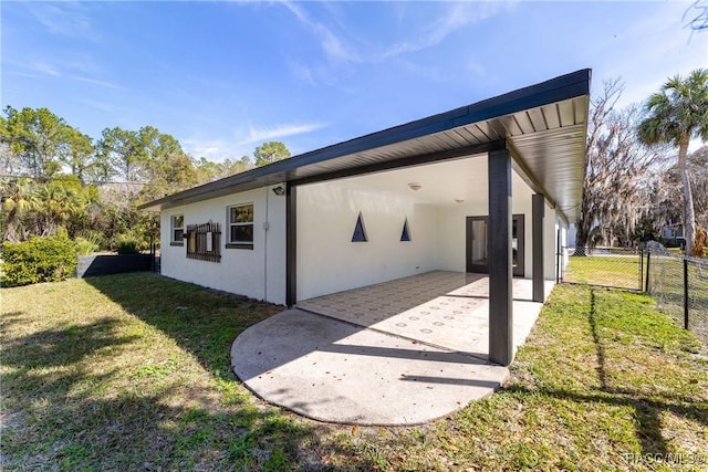 view of side of home featuring a yard and a patio