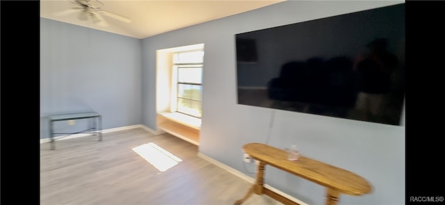 living room featuring light wood-type flooring and ceiling fan