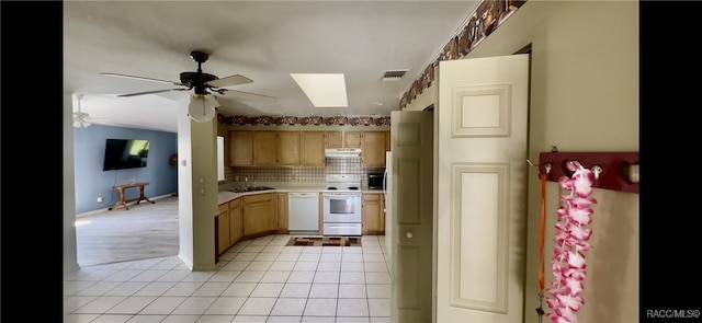 kitchen featuring tasteful backsplash, sink, light tile patterned floors, and white appliances