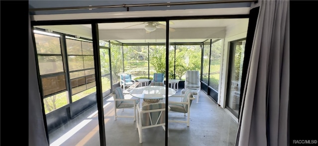 unfurnished sunroom featuring a wealth of natural light and ceiling fan