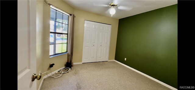 unfurnished bedroom featuring carpet flooring, ceiling fan, and a closet