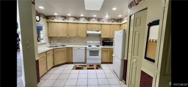 kitchen featuring backsplash, light brown cabinetry, white appliances, and sink