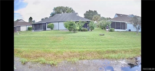 view of yard featuring a sunroom