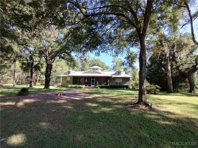 7802 N Fairwind Loop, Hernando, FL 34442 - view of grassy yard featuring a porch