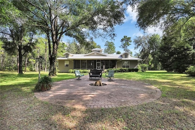7802 N Fairwind Loop, Hernando, FL 34442 - back of property with an outdoor fire pit, a sunroom, a lawn, and a patio