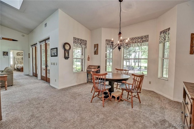 7802 N Fairwind Loop, Hernando, FL 34442 - carpeted dining area with a chandelier and vaulted ceiling