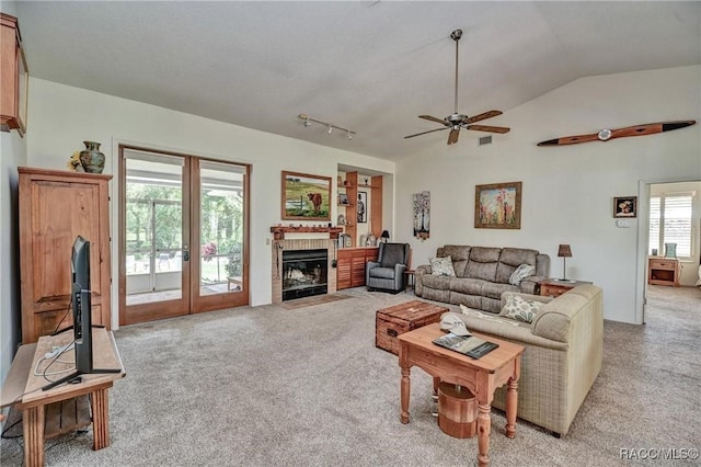 7802 N Fairwind Loop, Hernando, FL 34442 - living area with light carpet, lofted ceiling, ceiling fan, french doors, and a tile fireplace