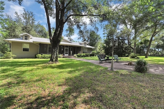 7802 N Fairwind Loop, Hernando, FL 34442 - view of green lawn featuring a sunroom and a patio area