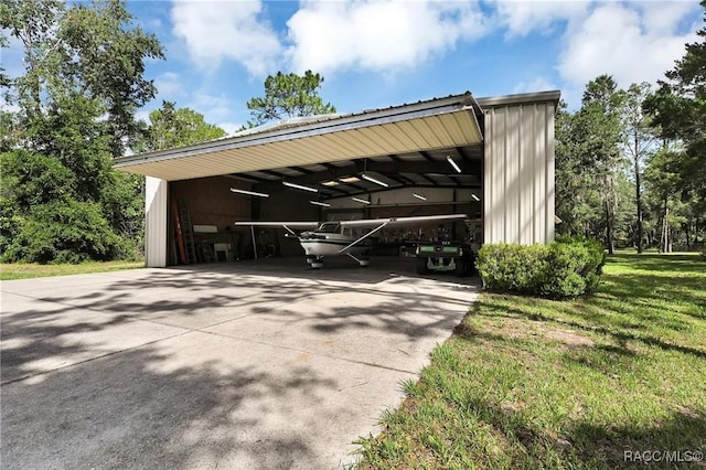 7802 N Fairwind Loop, Hernando, FL 34442 - view of parking featuring an outbuilding, a detached carport, and driveway